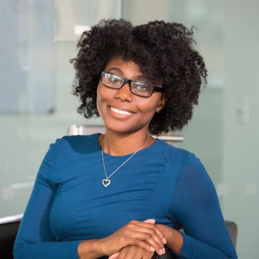 smiling woman sitting on black chair